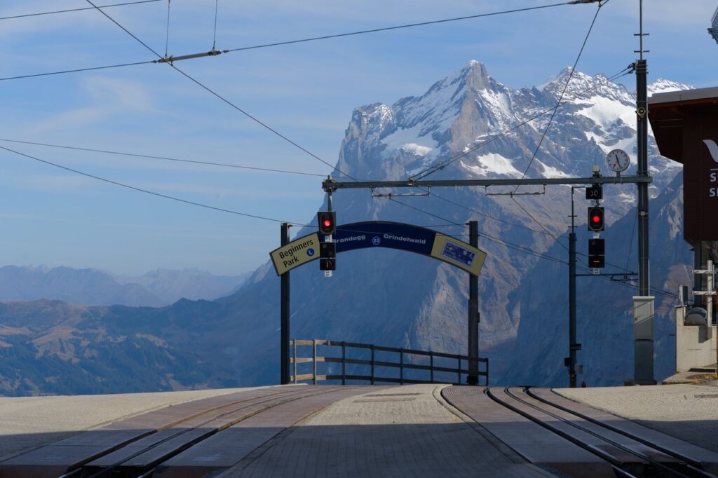 Scenic view of train station with Swiss Alps in the background. Perfect for travel enthusiasts.